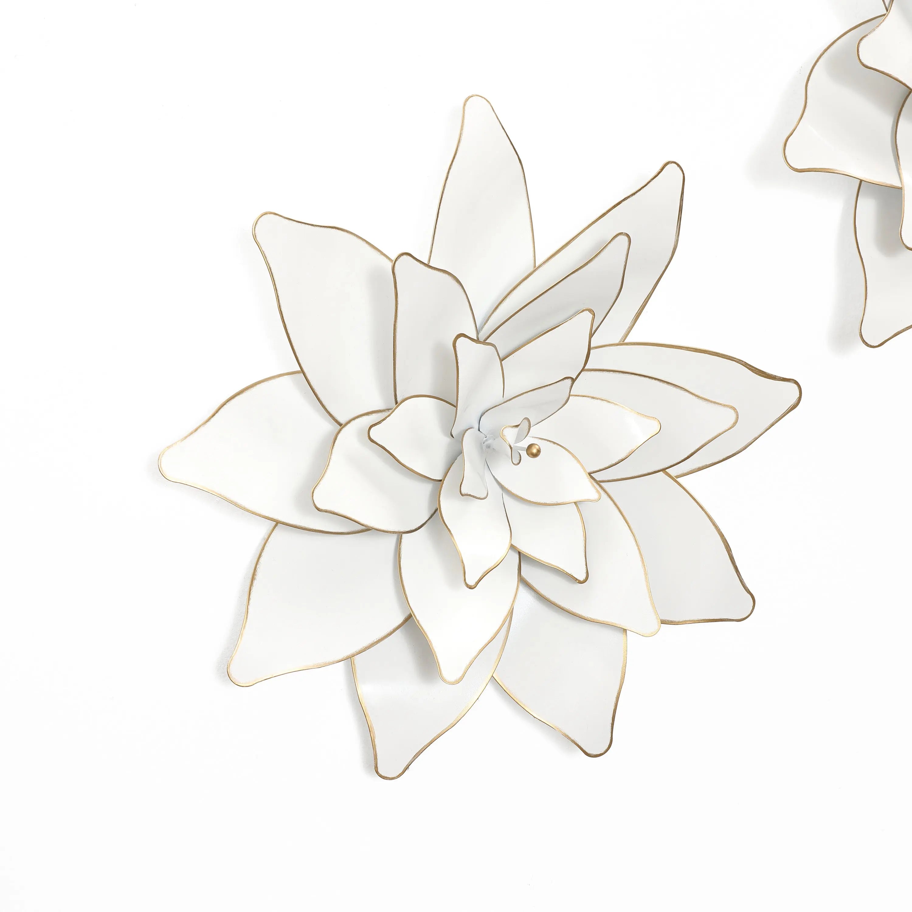 A stunning example of metallic art, this white decorative flower with gold edges stands out beautifully against a plain background.