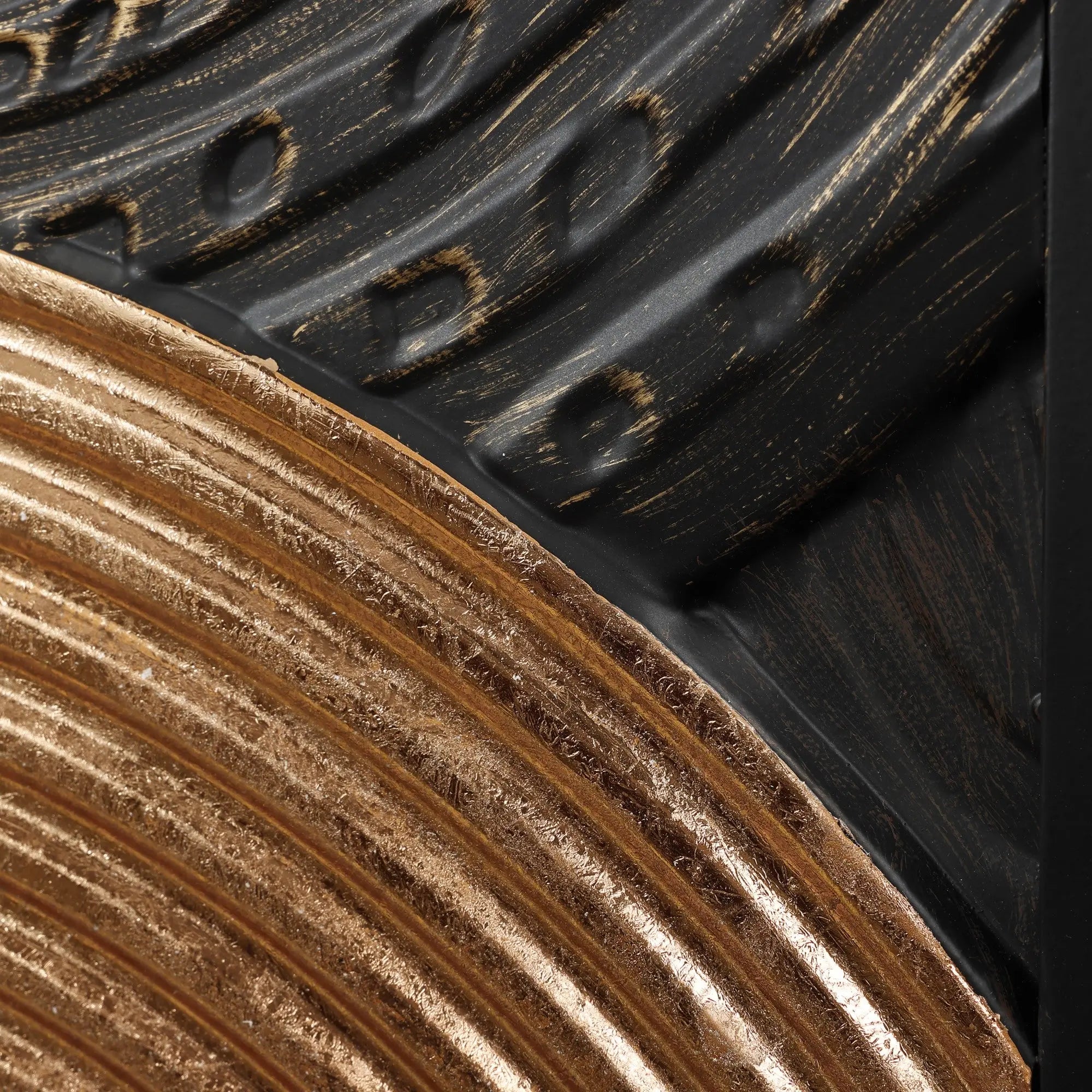 Close-up of embossed textures with curved patterns; one part is metallic bronze, the other black with gold brush strokes, creating an exquisite art piece perfect for wall decor.