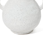 Close-up of a white, speckled ceramic pot with rounded handles, showcasing its textured surface and hinting at a vintage-inspired vase design.