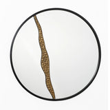 A round wall mirror with a black frame and an artistic design, featuring a wavy bronze accent that divides the surface vertically, perfect for modern decoration.