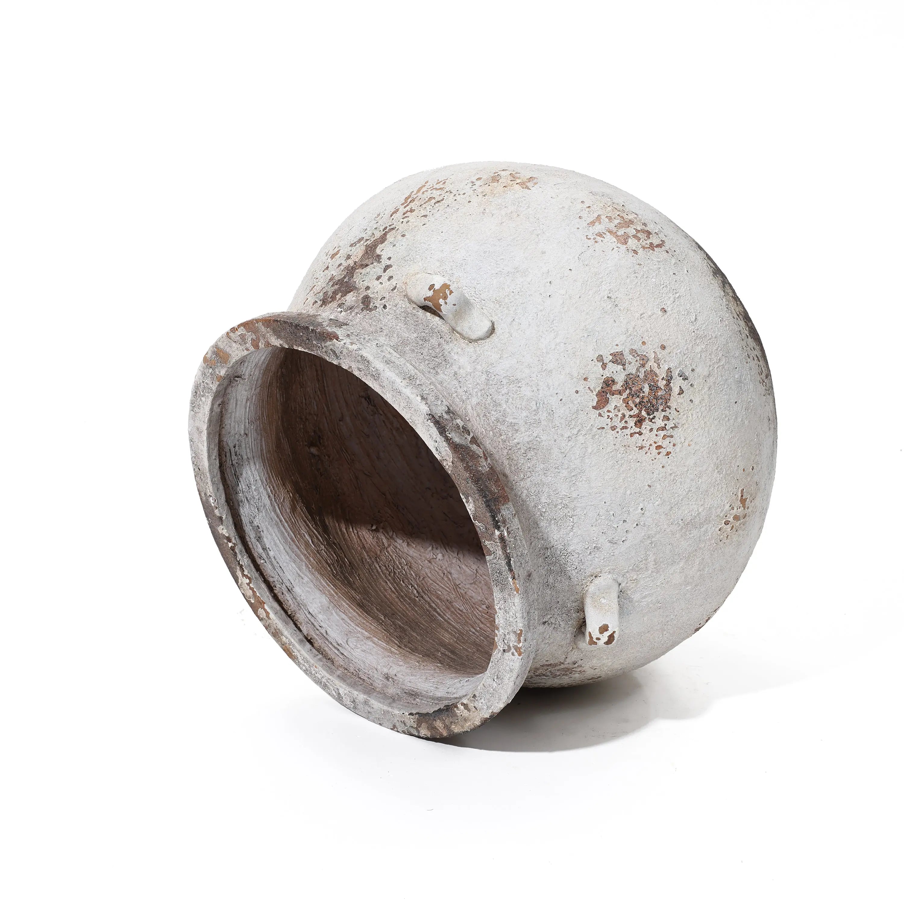 The LuxenHome Antique cauldron planter lies on its side, offering a vintage rustic look with an earthy, patchy clay texture in brown and gray. The round design includes a wide open mouth and small handles for added charm.