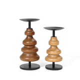 Two wooden candle holders with stacked, rounded shapes on black bases enhance your home decor. Crafted from birch wood, one is taller and darker, while the other is shorter and lighter.