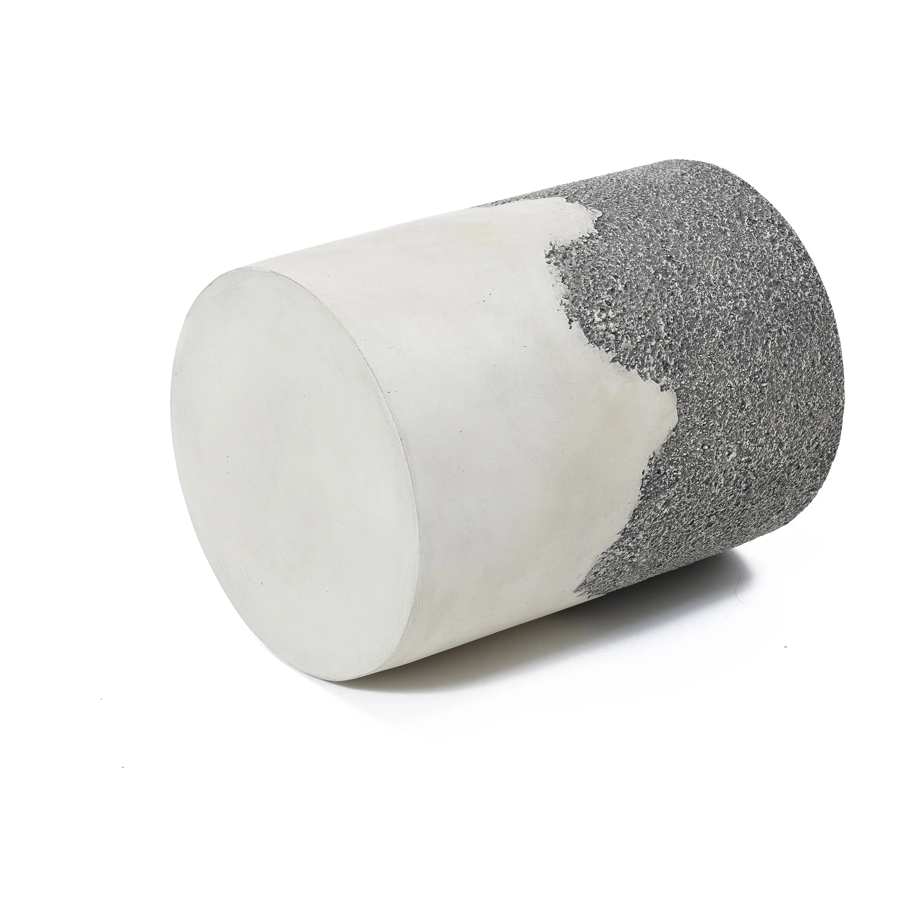 A cylindrical object with a smooth white surface on one half and a rough, textured grey surface on the other, reminiscent of an ombre style finish, is displayed against a plain white background.