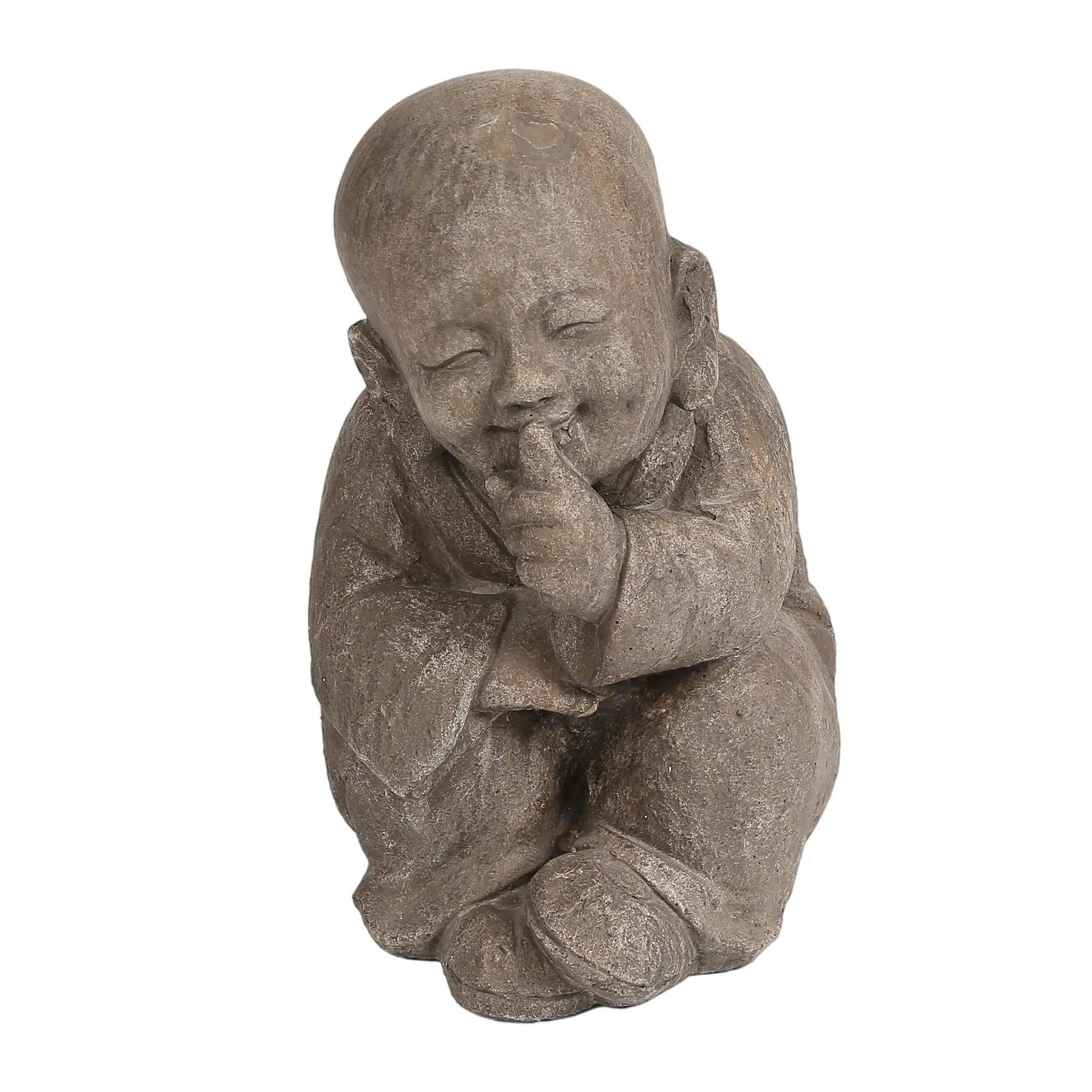 A weather-resistant Buddha garden statue of a child sits serenely, one arm on its knee and the other hand raised to its mouth, smiling peacefully with eyes closed.