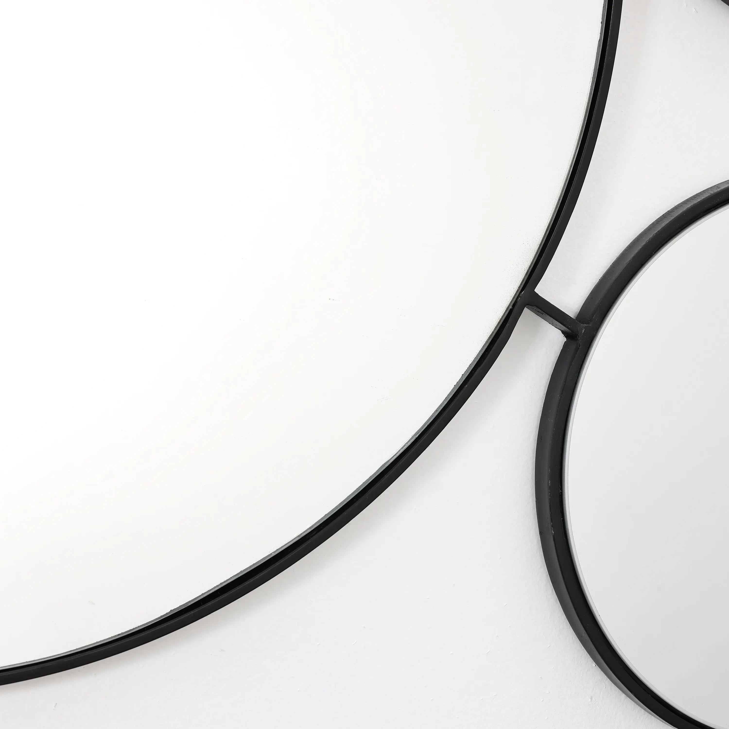 black-circular-mirror-and-a-white-circular-mirror-frame