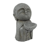 Gray stone Buddha monk statue of a small, smiling monk with closed eyes, holding a bowl in both hands, dressed in a simple robe—perfect as a serene garden statue or meditation centerpiece.