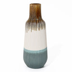 High-quality ceramic vase with vertical ridges, showcasing a colorful blend of brown, white, and blue sections. Its narrow opening adds an elegant touch to any home decor.
