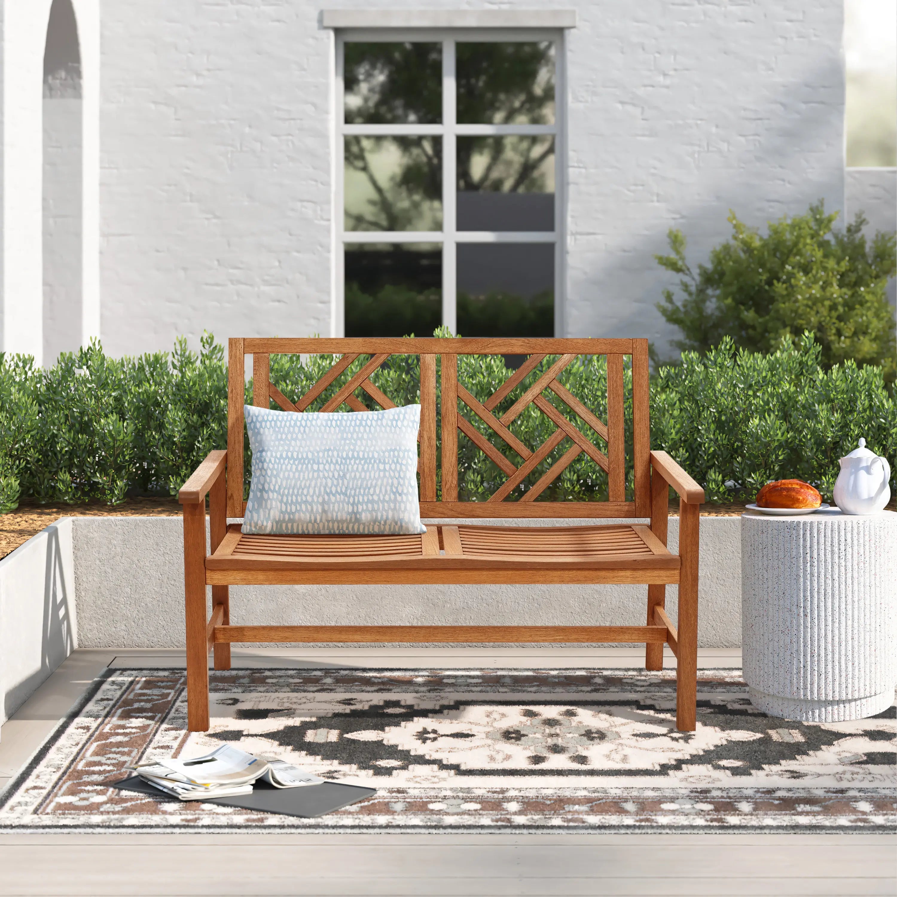 wooden-bench-and-a-rug-on-a-patio