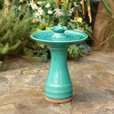 glazed-ceramic-bird-bath-standing-on stone-floor-in-tropical-garden