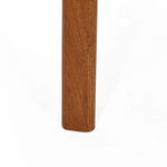 Close-up of a vertical wooden furniture leg crafted from solid Malaysian hardwood with a smooth, light brown finish, set against a plain white background.