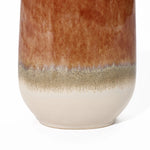 Close-up of a vintage ceramic vase with a glossy, reddish-brown top and textured, beige lower section, showcasing a striking color block gradient. Perfect for any home decor setting.