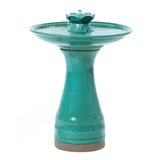 A decorative garden piece, this turquoise ceramic bird bath features a charming two-tiered fountain on a pedestal base.