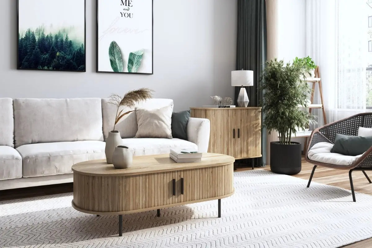 living room set up, ivory color vases set on top of wood accent coffee table in front of sectional sofa, sliding door accent cabinet at the back with black planters and wood accent chair by the side