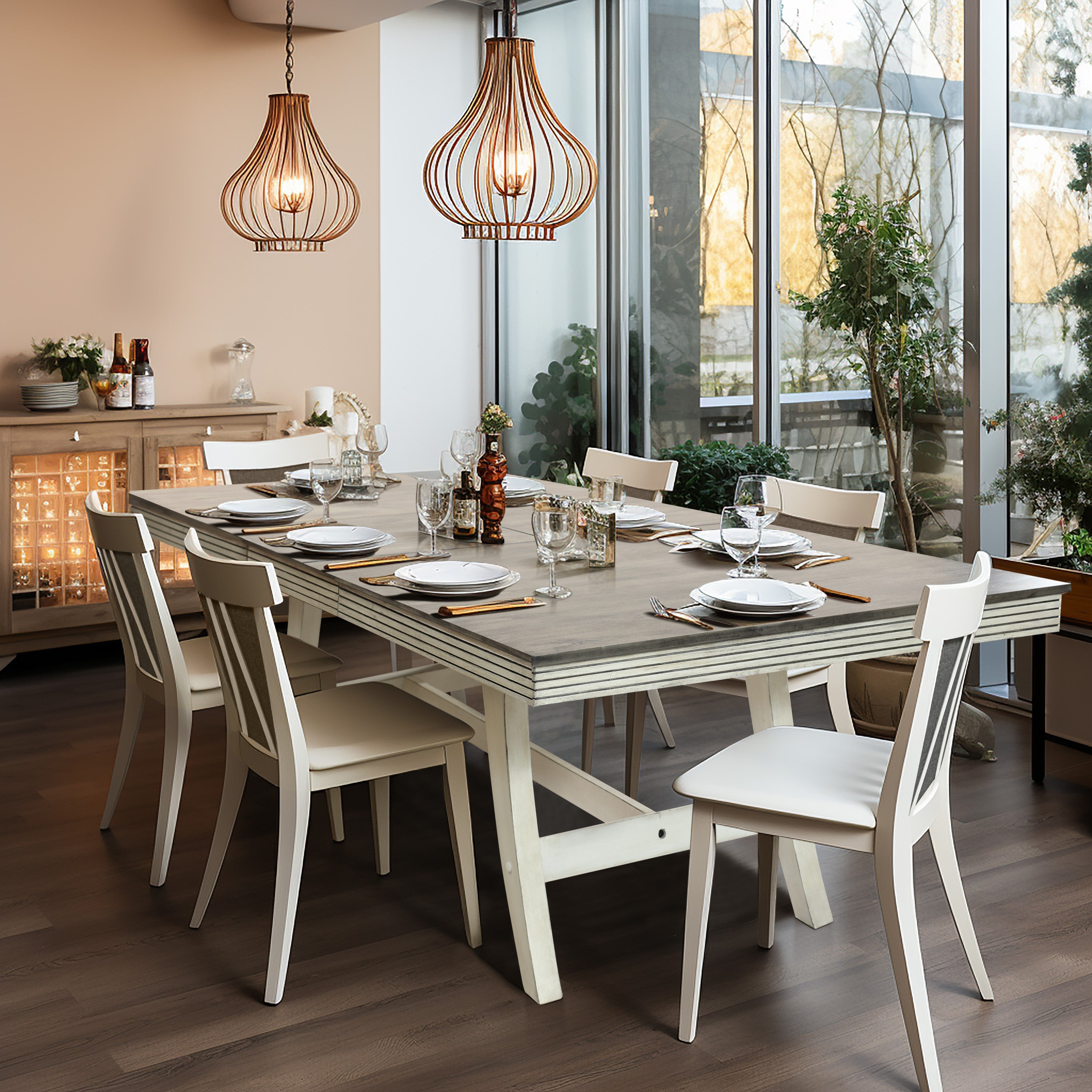 Modern dining room with a wooden table set for six, featuring white chairs, pendant lights, and a sideboard. Large windows provide natural light and greenery is visible outside.