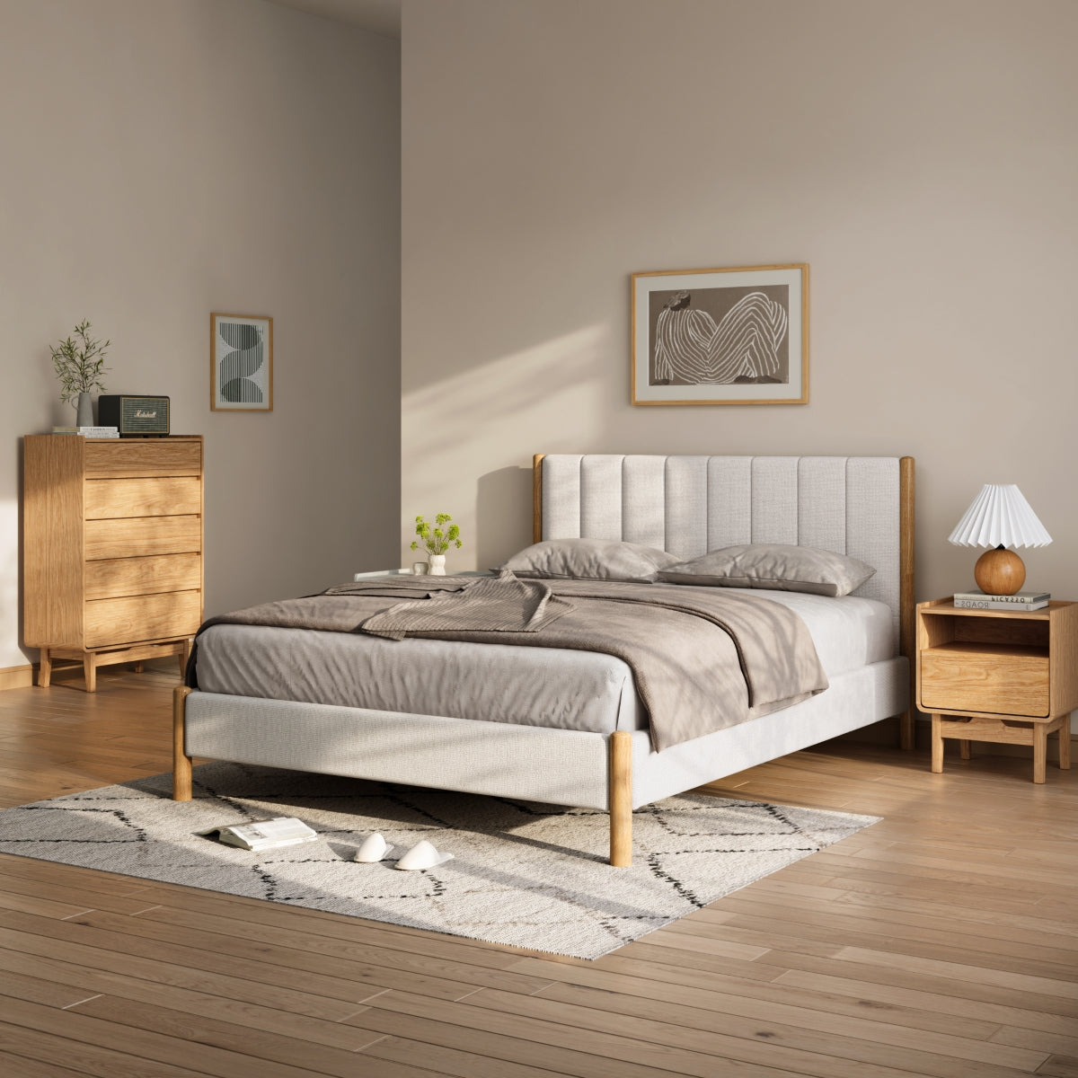 Minimalist bedroom with a wooden bed, gray bedding, a nightstand with a lamp, a dresser, wall art, and a light rug on a wooden floor.