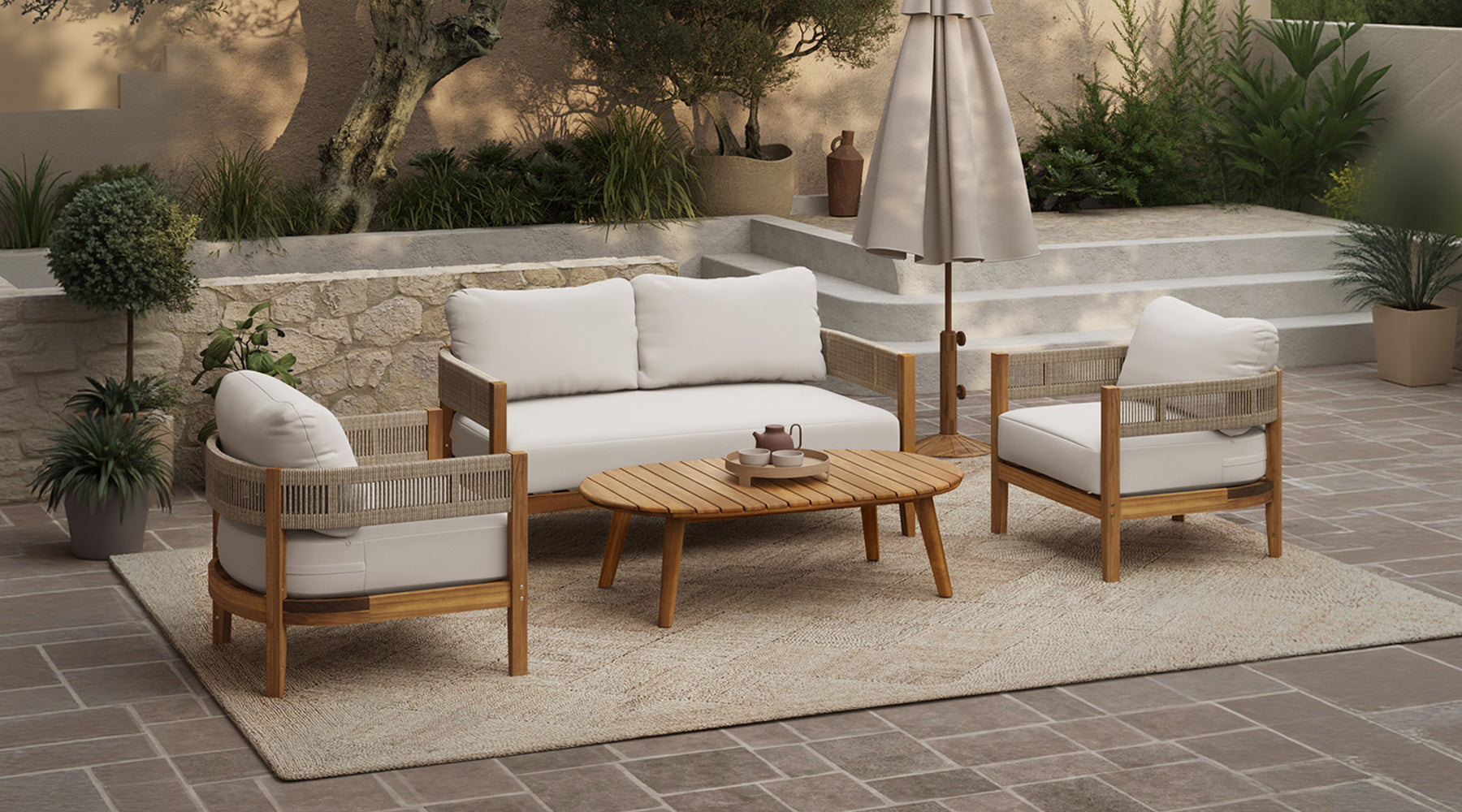 A wooden outdoor dining table with matching chairs is set on a tiled patio beside a swimming pool, with greenery and modern white walls in the background.