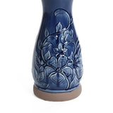 Blue ceramic birdbath with petals and vines pattern