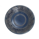 Blue ceramic birdbath with leaves and swirl pattern