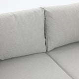 Close-up of a gray fabric couch with two backrest cushions meeting at the center seam, reminiscent of an outdoor loveseats cozy design, yet refined enough for indoor elegance.