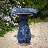 Blue ceramic birdbath with petals and vines pattern