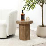 A cozy living room scene features the LuxenHome Dark Oak finish fluted round side table, adorned with a whiskey bottle and glass. Its next to a plush white armchair and potted plant, completed by light pouring through a nearby window, casting soft shadows for a modern aesthetic.