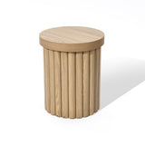 A round wooden end table with a fluted drum design, featuring a flat circular top and a column-like base in an elegant oak finish.