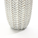 A close-up of the LuxenHome Modern geometric pattern resin tall vase (25 h) showcases a textured design with overlapping leaf or feather-like patterns. Alternating white and natural clay colors create a woven appearance against a plain white background.