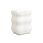A white, ceramic stool with a wavy, ribbed design and a rectangular top perfectly embodies modern home furnishings.