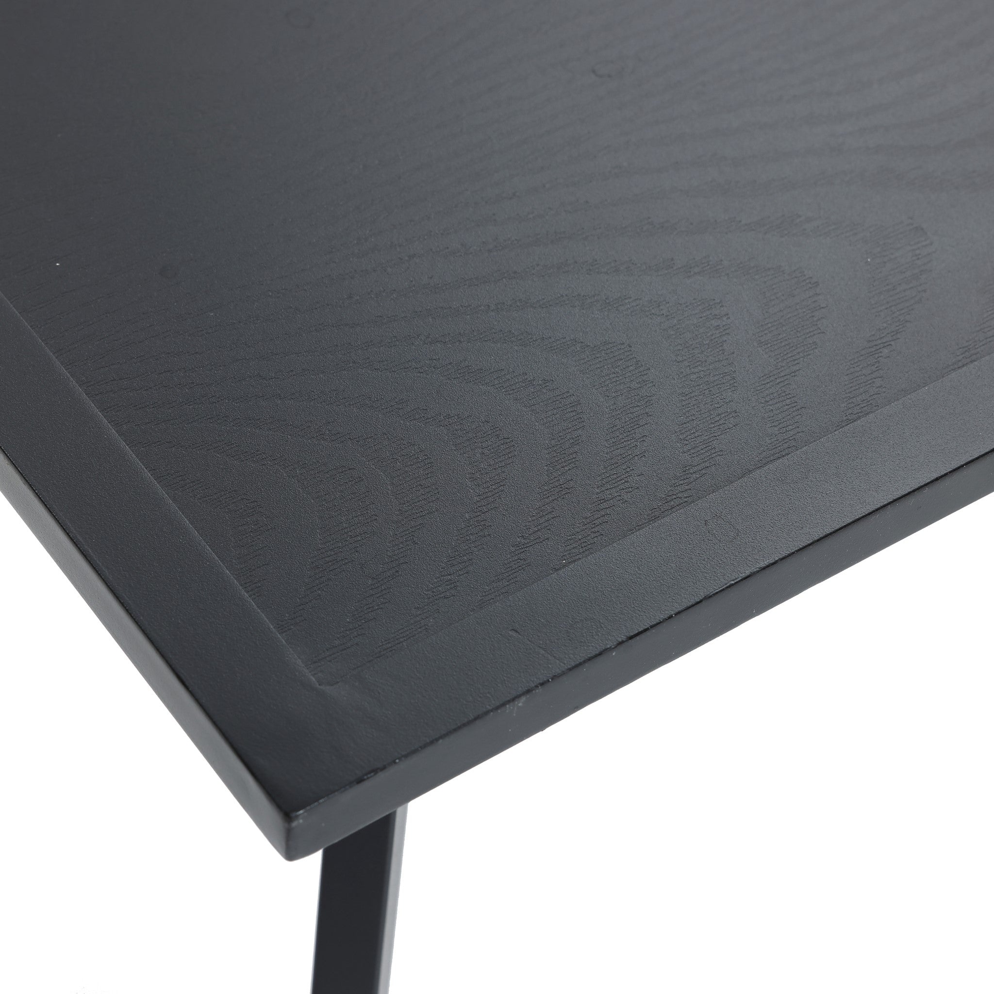 Close-up of a black steel table corner from an outdoor conversation set, showcasing a textured surface and sleek edges.