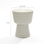 The Meru outdoor side table by LuxenHome features a minimalist design with a textured ceramic look, showcasing a cylindrical base and wider top with vertical white stripes. Made from magnesium oxide, it measures 12.99 inches in diameter and 15.94 inches in height, all in light beige.