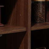 Close-up of the Aria 2-door tambour accent cabinet by LuxenHome, in a dark oak finish. The wooden unit has intersecting shelves, one with a glass jar of coffee beans. Visible small holes suggest adjustable shelves or tambour door functionality.