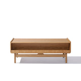 The Eric coffee table by LuxenHome, featuring a minimalist mid-century modern design with an oak finish and rectangular shape, includes a closed storage compartment and stands on four sturdy legs. Its displayed against a white background.