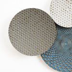 Abstract wall art featuring three overlapping circular metal plates with textured patterns in gray, white, and blue. This unique piece serves as a stunning multi-color wall decor that brings a touch of elegance to any room.