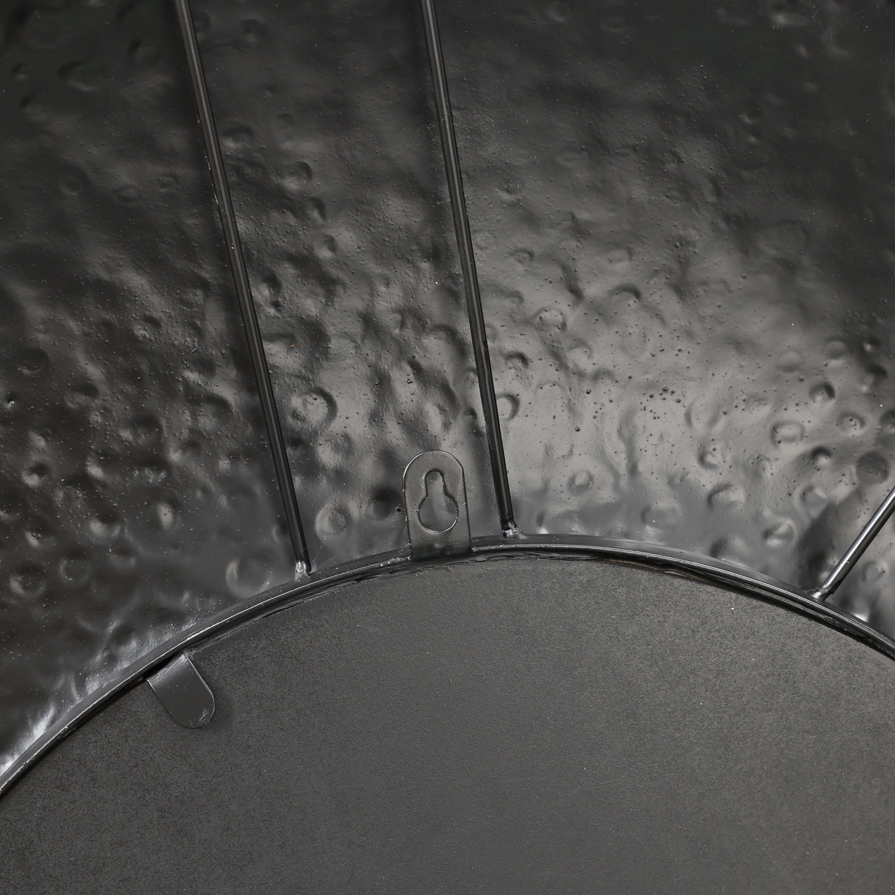 back panel of a wall mirror, in black color, close up to the hanging mechanism