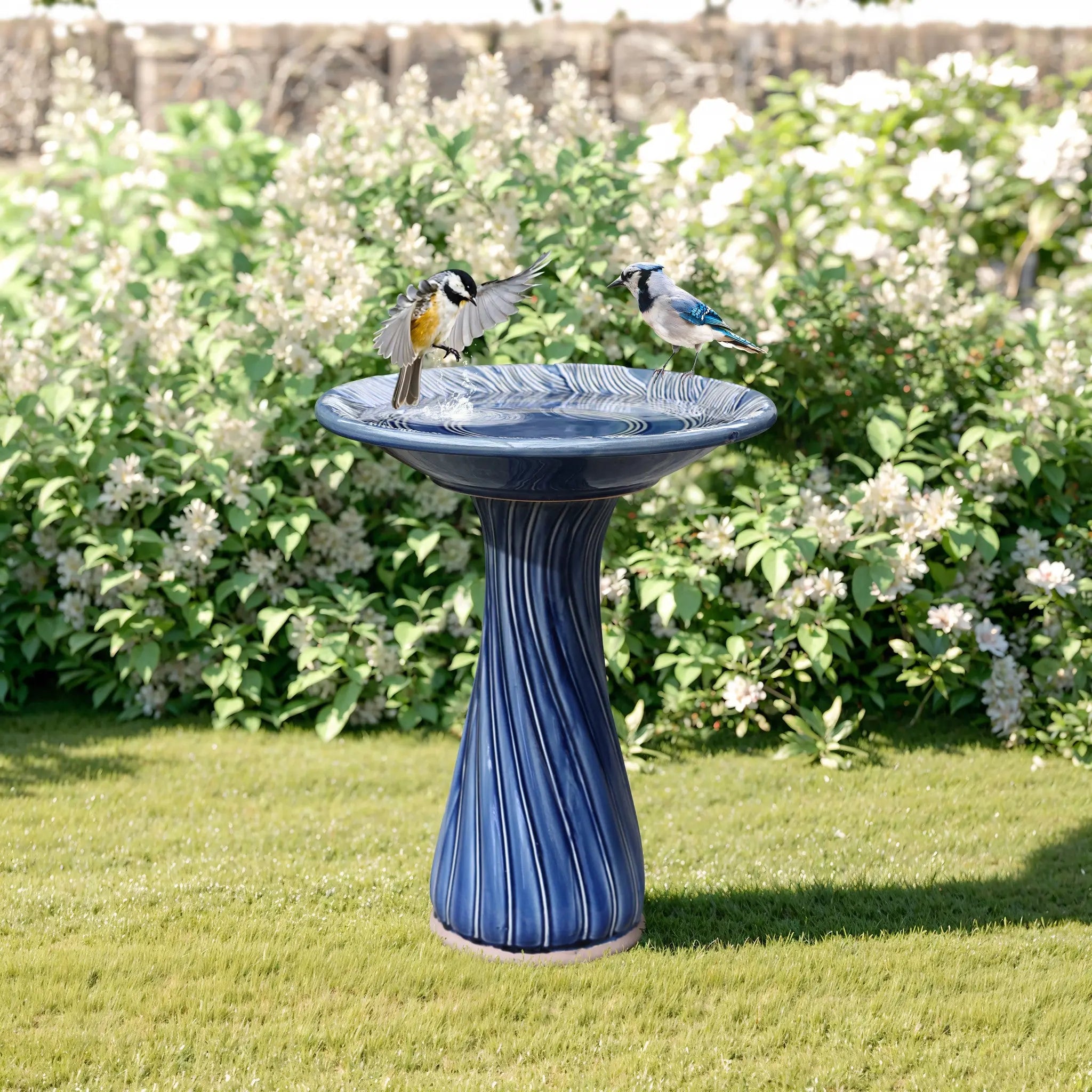 blue ceramic birdbath with leaves and swirl pattern
