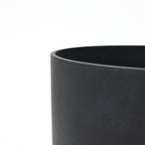 Close-up of the top edge of a smooth, black, cylindrical planter set against a white background, showcasing its durable design perfect for outdoor use.