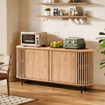 In a modern kitchen setting, an oak wood grain finish mid-century modern buffet cabinet complements the toaster, oven, and bowl of lemons. Two shelves above hold mugs and spices, while a plant stands gracefully to the right.