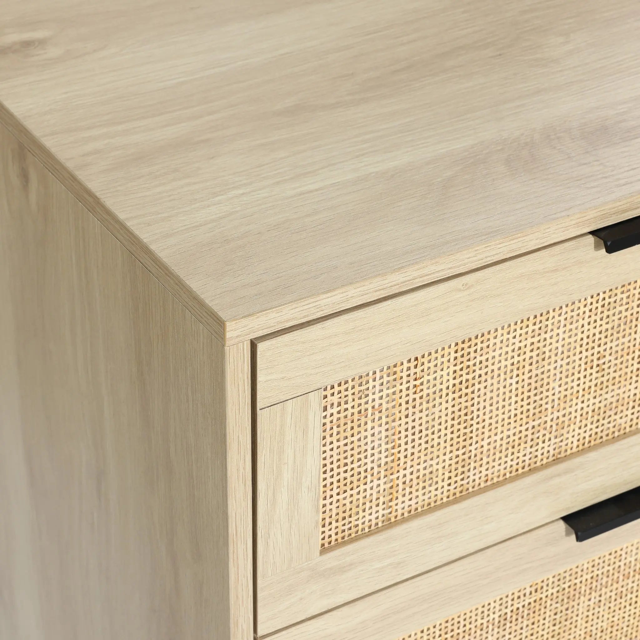 close-up to the top panel of a light wood rattan dresser