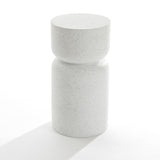 The Speckled White Pillar Outdoor Side Table boasts a minimalist cylindrical design with light gray terrazzo. Its contemporary flair comes from a wider top and narrow middle, resembling a chic stool. Set against a plain white background, it highlights elegant simplicity.