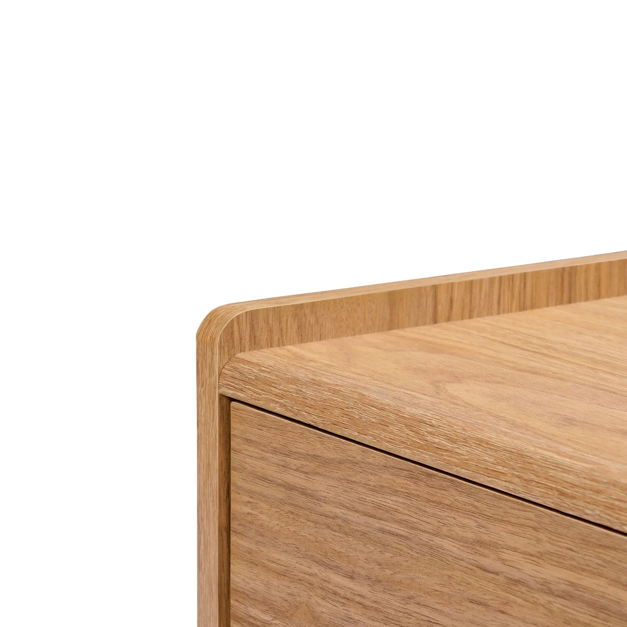 Close-up of the Eric oak finish 70 TV stand by LuxenHome reveals smooth edges and natural wood grain. The light brown finish and minimalistic design create a modern, elegant aesthetic, making it an ideal piece for any mid-century modern setup. Suitable for TVs up to 75.