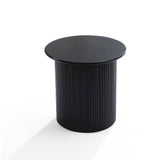 A black round side table with a vertically ribbed cylindrical base stands against a white background, exuding a modern style with its sleek lines and decorative effect.