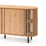 This mid-century modern buffet cabinet showcases vertical slat detailing on its sides. Crafted with an oval shape and standing on black metal legs, it boasts a decorative oak wood grain finish, making it a stylish addition to any space.