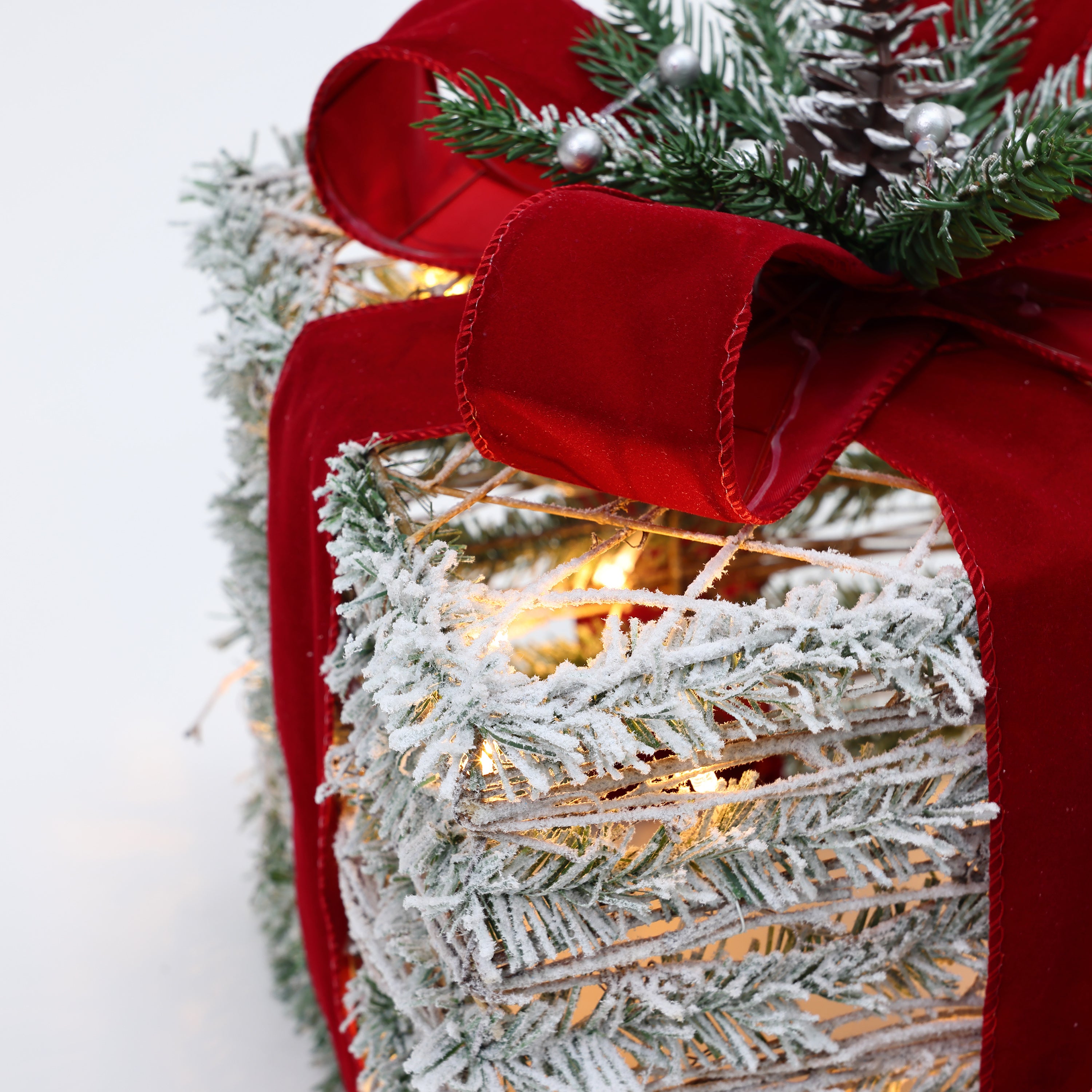 gift-boxes-christmas-decorations-are-festively-decorated-with-silver-berries-pine-needles-pinecones-and-red-ribbon