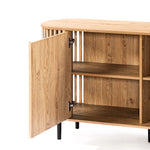 This decorative cabinet features an open door revealing spacious interior shelves. With its light oak wood grain finish and sleek black legs, it embodies a mid-century modern buffet cabinet style.