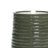 Dark green ceramic cylindrical object with ribbed design and a small flame-like feature on top, resembling a candle.