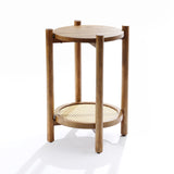 A round wooden side table with a chestnut finish and two levels, featuring a solid top crafted from pine and MDF wood and a woven rattan bottom shelf. It has four vertical cylindrical legs.