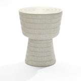 The LuxenHome Meru outdoor end/side table in light beige is crafted from durable magnesium oxide and showcases a modern, minimalist look with its drum shape. It features a textured surface with vertical white dashes, making it suitable for any setting.