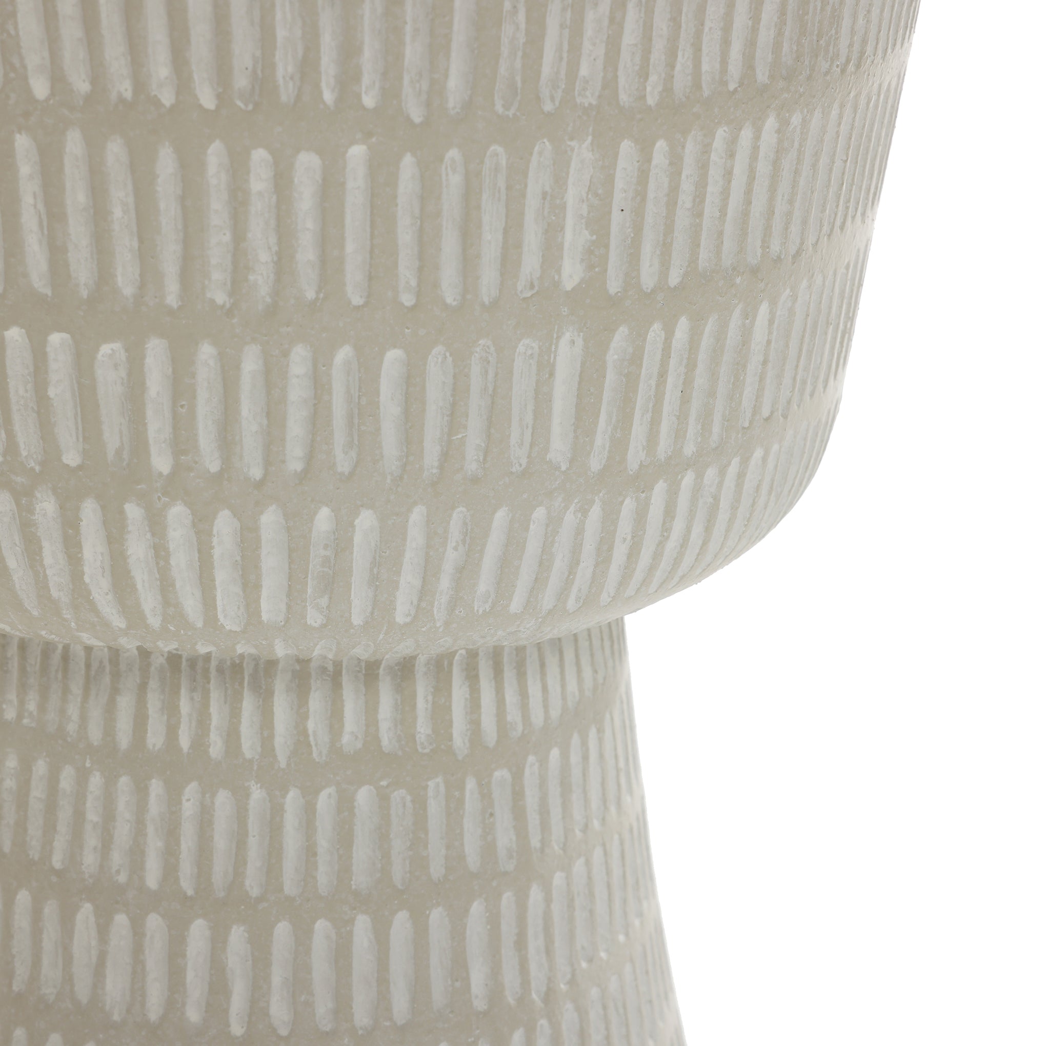 A close-up of a gray textured ceramic vase crafted from magnesium oxide, featuring vertical lines. Its rounded top and narrower base exhibit a minimalist design ideal for pairing with the LuxenHome Meru outdoor end/side table in beige.