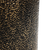 Close-up of a textured surface with a dark brown and gold pattern, resembling small bumps or pebbles, much like the intricate design of a hammered iron base.