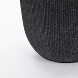 Close-up of a textured, dark gray ribbed fabric surface with a curved edge on a light background, reminiscent of the minimalist design planters its meant to complement.